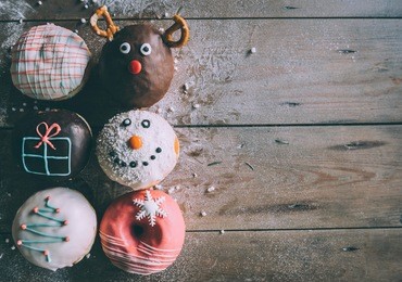 christmas donuts served on wooden background with blank space