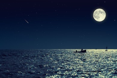 scenic view of small fishing boat in calm sea water at night and full moon. 