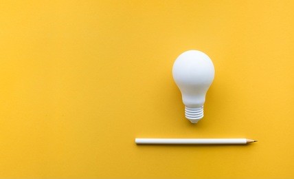 creativity inspiration,ideas concepts with lightbulb and pencil on pastel color background.flat lay design.