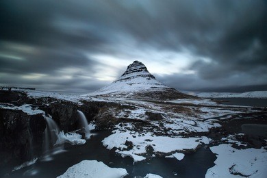 long exposure of kirkjufell mountain under moving cloud, iceland