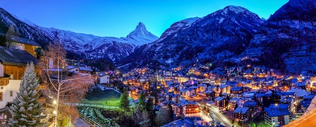 beautiful view of old village in twilight time with matterhorn peak background in zermatt, switzerland.
