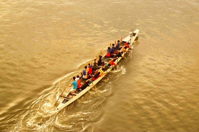 dragon boat participant practice during sunset.