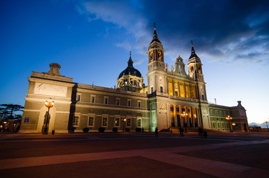 front view of catedral de la almudena in madrid (spain) during the blue hour. illuminated at night.