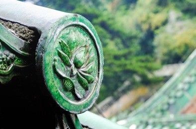 the ancient green glazed tile roof and decorate with the lotus line located in the temple of wudang mountain, it's chinese style. hubei , china it's special name.