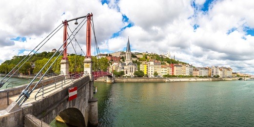 pedestrian saint georges footbridge and the saint georges church in lyon, france in a beautiful summer day