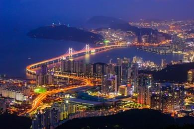 geangan bridge and haeundae beach at night in busan city, south korea.