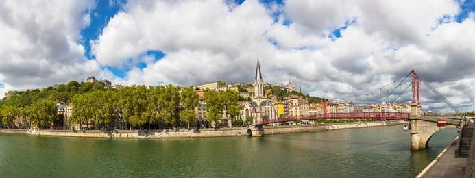 pedestrian saint georges footbridge and the saint georges church in lyon, france in a beautiful summer day