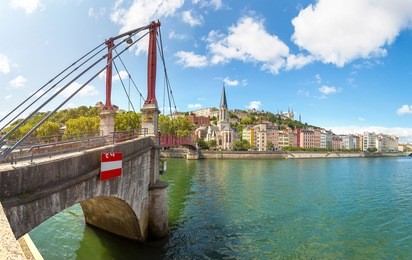 pedestrian saint georges footbridge and the saint georges church in lyon, france in a beautiful summer day