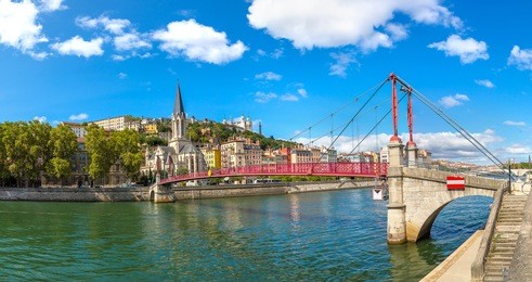pedestrian saint georges footbridge and the saint georges church in lyon, france in a beautiful summer day