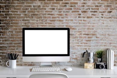 loft workspace concept. mock up white screen modern desktop computer and books, minimal stuff on desk.