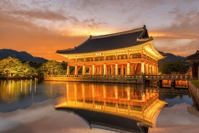 gyeongbokgung palace at night in south korea, with the name of the palace 'gyeongbokgung' on a sign