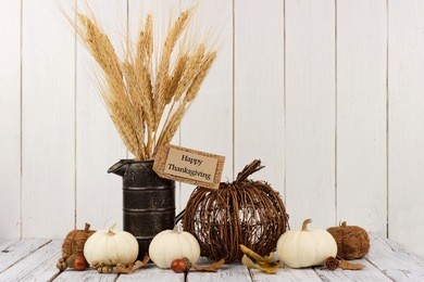 happy thanksgiving tag, pumpkins and autumn home decor with a white wood background
