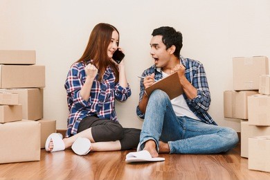 young couple checklist with cardboard box at home - business online and delivery concept
