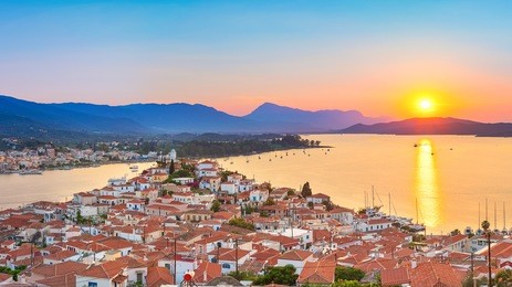 sunset on poros island in aegean sea, greece