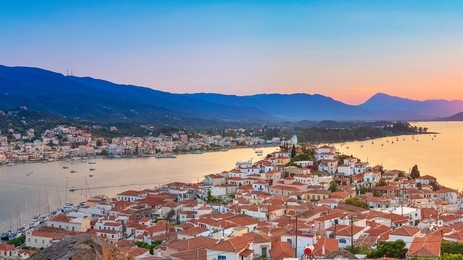 sunset on poros island in aegean sea, greece