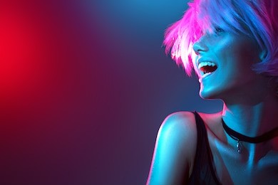 high fashion model woman in colorful bright lights posing, portrait of beautiful  girl with trendy make-up. art design, colorful make up. over colourful vivid background