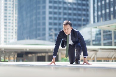 businessman getting ready for race in business.