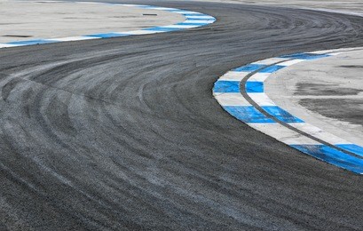 motor racing track circuit, turning asphalt road with marking lines and tire marks, motor racing track asphalt international race track circuit.