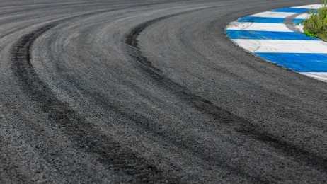 motor racing track circuit, turning asphalt road with marking lines and tire marks, motor racing track asphalt international race track circuit.