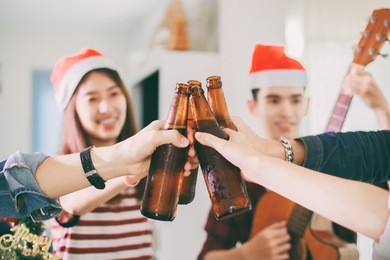 asian group of friends having party with alcoholic beer drinks and young people enjoying at a bar toasting cocktails.soft focus