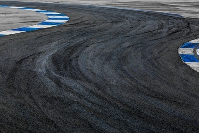 motor racing track circuit, turning asphalt road with marking lines and tire marks, motor racing track asphalt international race track circuit.