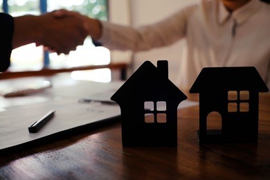 real estate agent handshake. business partnership meeting concept. and home insurance 