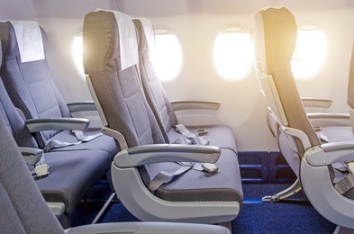 armchairs in passenger cabin, with safety belts and portholes