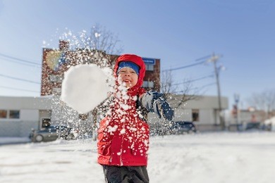 boy throws snowballs. winter fun outdoors
