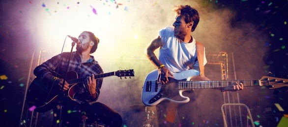 flying colours against male guitarists performing on stage