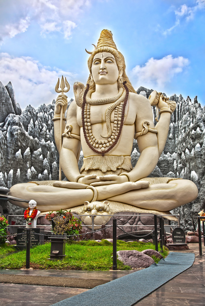 big shiva statue sitting in lotus with trident in his hand and cobra near by. bangalore, india