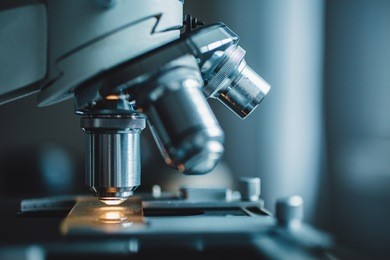 close-up shot of microscope with metal lens at laboratory.
