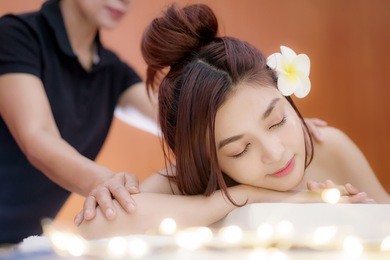 beautiful young asian woman relaxing with hand spa massage at beauty spa