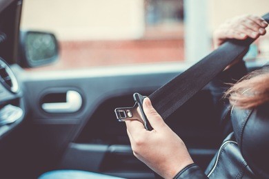 passenger woman fastening seat belt in the car, safety concept (color toned image)