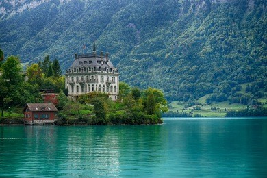 schloss seeburg, seeburg castle, in iseltwald with teal colored water of lake brienz.