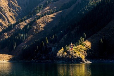 alone pagoda in tianshan lake with sunlight. it is famous attraction spots of xinjiang, china