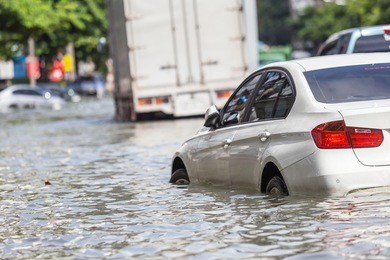 car parking on the street and show level of water flooding in bangkok, thailand