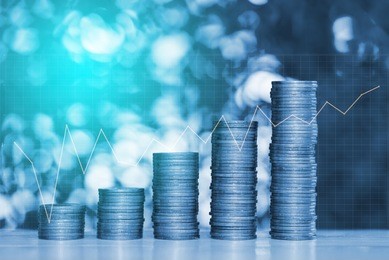 double exposure of stacks of coins on the table in garden with financial graph chart, finance banking and business concept.