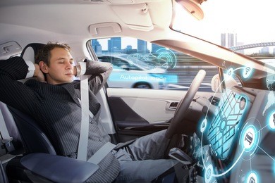caucasian man sleeping in autonomous car. self driving vehicle.