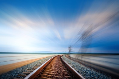 motion on railroad bridge curve track over the lake, blue sky