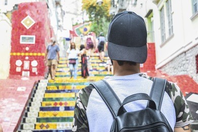 man walking on selaron stairway in rio de janeiro, brazil
