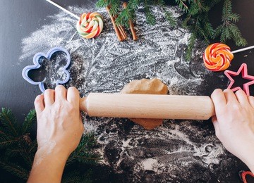 woman hands making ginger pastry, cookie cutters
