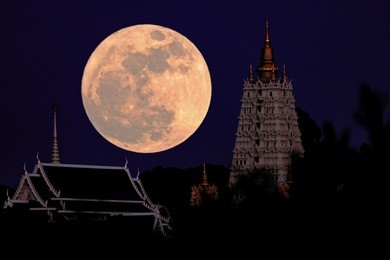 the big moon is above the pagoda.