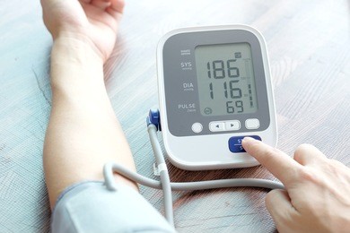 man check blood pressure monitor and heart rate monitor with digital pressure gauge. health care and  medical concept