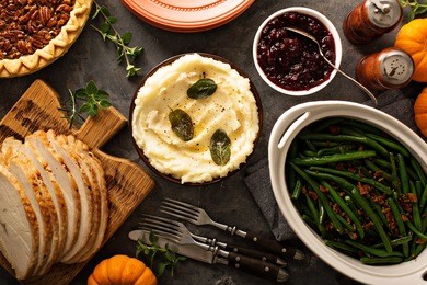 mashed potatoes with butter and sage, side dish for thanksgiving or christmas dinner overhead shot