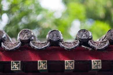 beautiful eaves with traditional chinese symbolic sculpture at prince gong's mansion in beijing, china