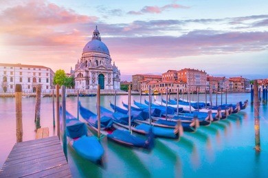 grand canal in venice, italy with santa maria della salute basilica in the background at twilight
