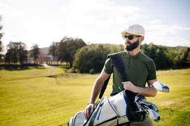 stylish multicultural friends spending time together while playing golf on golf course