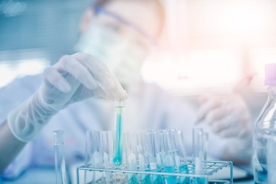 asian women scientist with test tube making research in clinical laboratory.science, chemistry, technology, biology and people concept