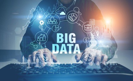 unrecognizable man wearing a sweater and typing at a keyboard in a room. a glowing big data hologram in the foreground. toned image double exposure