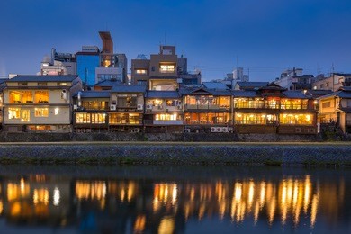 old house and restaurant in kamo river or kamogawa river at sunset